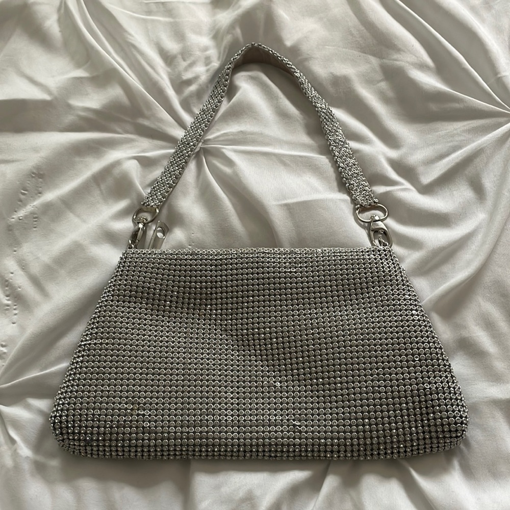 Sliver rhinestone purse with handle.
